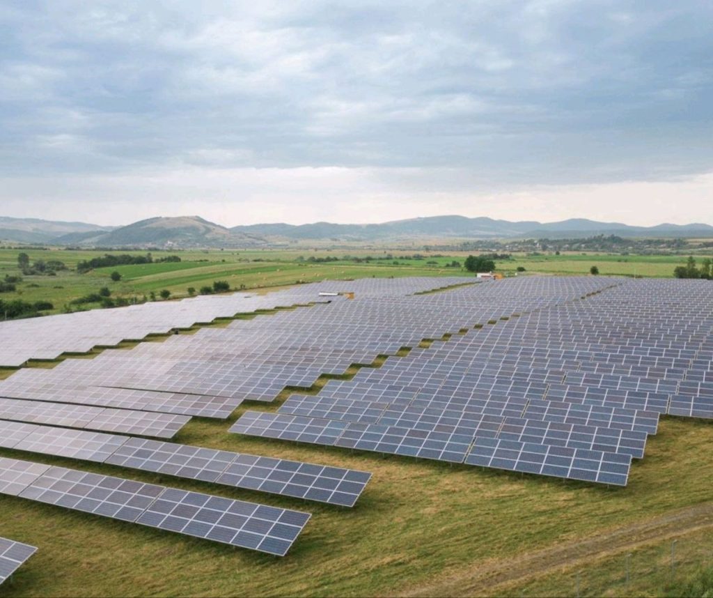 Вид сверху на крупную солнечную электростанцию, установленную на сельскохозяйственных полях — масштабный проект для фермеров и бизнеса.